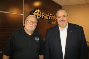James Dowd, Pathfinder Bank President and CEO, presents a check representing the bank’s support of Harborfest’s annual fireworks display to Dan Harrington, Harborfest Executive Director.