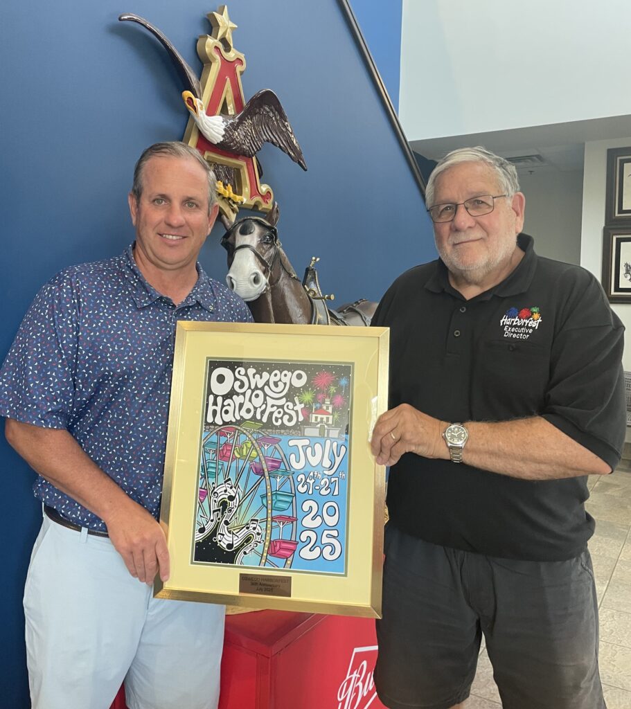Harborfest Executive Director Dan Harrington presents the 2025 Harborfest poster to Daniel Dorsey, President of Eagle Beverage Co.